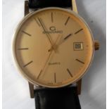 A gentleman's 9ct gold quartz wristwatch, by Garrard, gold textured dial with applied hourly