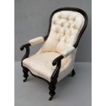 A George IV mahogany-framed armchair with button-back fabric upholstery, carved arms on fluted