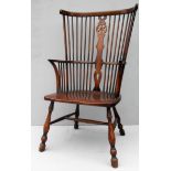 A walnut framed high-back Windsor chair with spindle and wheelback arched support, elm seat
