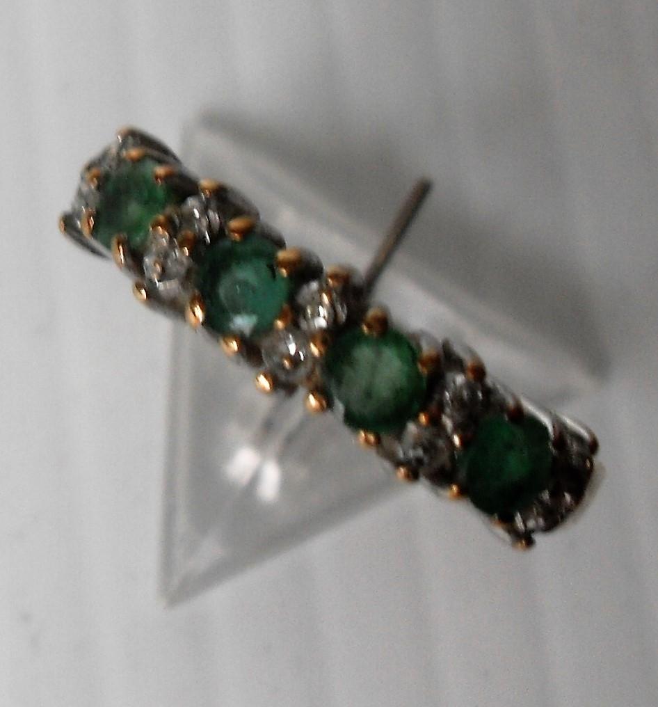 A 9ct yellow gold four-stone emerald ring with diamond accents in a claw setting, 2.04g, size L