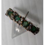 A 9ct yellow gold four-stone emerald ring with diamond accents in a claw setting, 2.04g, size L