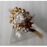 An 18ct yellow gold diamond crossover ring with brilliant-cut central stone in a claw setting, 3.4g,