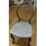 A set of six Victorian walnut spoon-back dining chairs with carved top rails, fabric upholstery