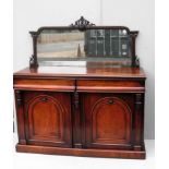 A Victorian mahogany sideboard with carved, mirrored tray-back, dummy frieze drawers, two-door