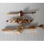 Three 9ct yellow gold bar brooches, two with amethyst stone decoration, the other with seed