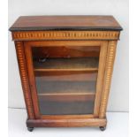An early 19th century mahogany and crossbanded pier cabinet, ebonised rim to top, single glazed door