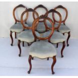 A set of six Victorian walnut spoon-back dining chairs with carved top rails, fabric upholstery