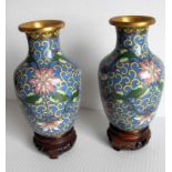 A pair of early 20th century blue-ground Oriental cloisonné vases on carved wooden stands, 14 cm