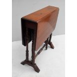 A late Victorian walnut Sutherland table with twin drop leaves, gate-leg action on trestle supports,