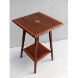 An Edwardian mahogany and crossbanded square occasional table with shell marquetry decoration to