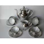 An Italian 20-piece white porcelain coffee set with silver overlay, signed E. B. , some minor wear