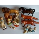 An assortment of Beswick figurines to include lion, horse, foxes x 2 (one with tail repaired), ducks