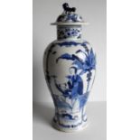 A 19th century Chinese blue and white baluster-shape vase with lid depicting a scholar and boy,