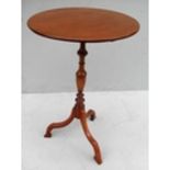 A 19th century walnut circular tripod table with turned support, 65 cm H