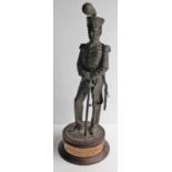 A finely detailed bronzed resin figurine of a Huzzar with dedication plaque dated 1989, 28 cm H