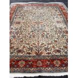 A William Morris-inspired hand-knotted wool rug with elaborate multi-coloured floral and Iznak