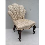 A Victorian mahogany-framed lady's chair with scallop-shape support, fabric upholstered on