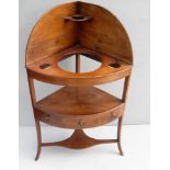 A Regency mahogany corner wash stand with three central drawers, brass handles, on splayed legs