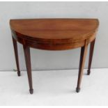 A Regency mahogany demi-lune card table with gate-leg action, baize top, all-over string inlay, oval