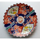 A late 19th century Imari plate with blue and ochre decoration,