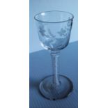 An 18th century wine or cordial glass, the double ogee, wrythen moulded and etched bowl, supported