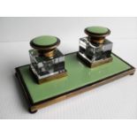 An Art Deco brass and cut-glass double inkwell desk set, 19.5 cm W, minor chips to two bottom