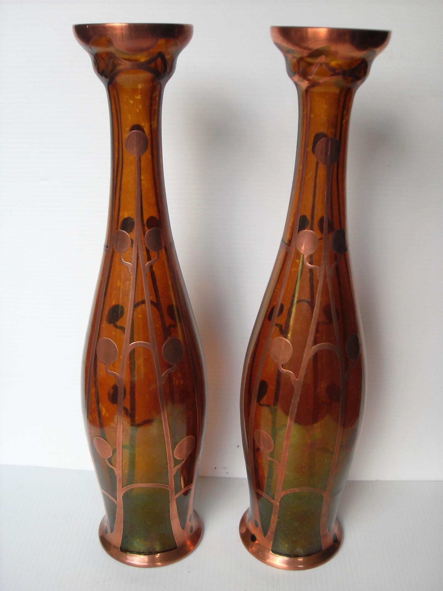 A pair of Art Nouveau secessionist Bohemian orange glass vases with copper overlay floral design,