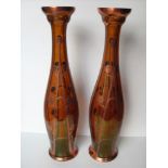 A pair of Art Nouveau secessionist Bohemian orange glass vases with copper overlay floral design,