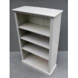 A white painted free-standing bookcase with adjustable shelves on a plinth base, 107 x 67 x 28 cm