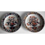Two early 19th century Japanese Imari plates with blue, ochre and gilt basket of chrysanthemum