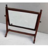 A 19th century mahogany vanity mirror with reeded supports on a stretcher base, 45 x 47cm and a
