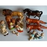 An assortment of Beswick figurines to include lion, horse, foxes x 2 (one with tail repaired), ducks
