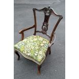 A late Victorian walnut low carver with extensive fretwork to splat, fabric upholstery on cabriole