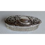 An Edwardian elliptical silver-topped cut-glass vanity jar with profuse rococo embossed