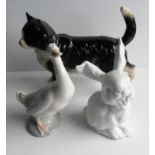 A Kaiser white porcelain laughing rabbit, a NAO duck and an indistinctly marked ceramic cat, all