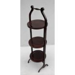 An Edwardian mahogany 3-plate adjustable cake stand on stretcher supports, 90 cm H