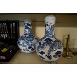 A pair of modern Chinese blue and white vases, relief decorated with dragons, blue mark to base.