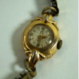 Omega: A Ladies manual wind wristwatch, with gold back,