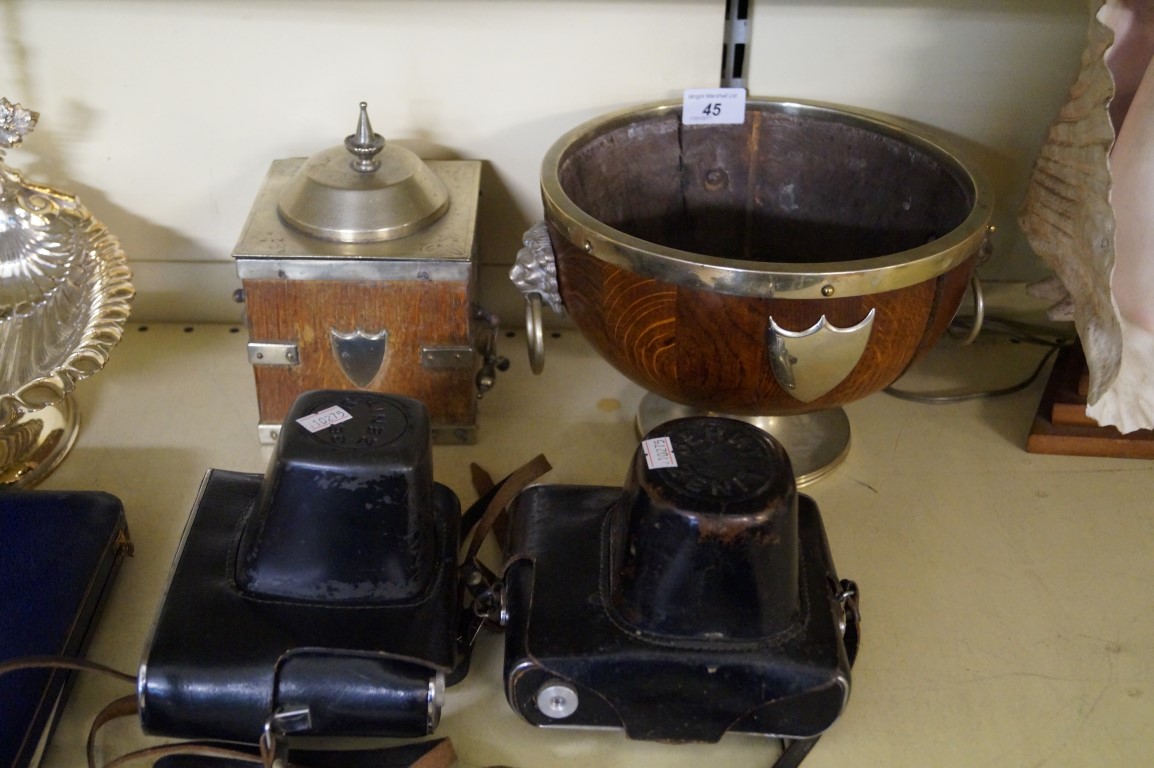 An early 20th Century oak solid bowl with silver plated mounts, together with a similar tea caddy,