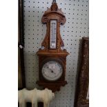 A late 19th Century carved oak barometer.