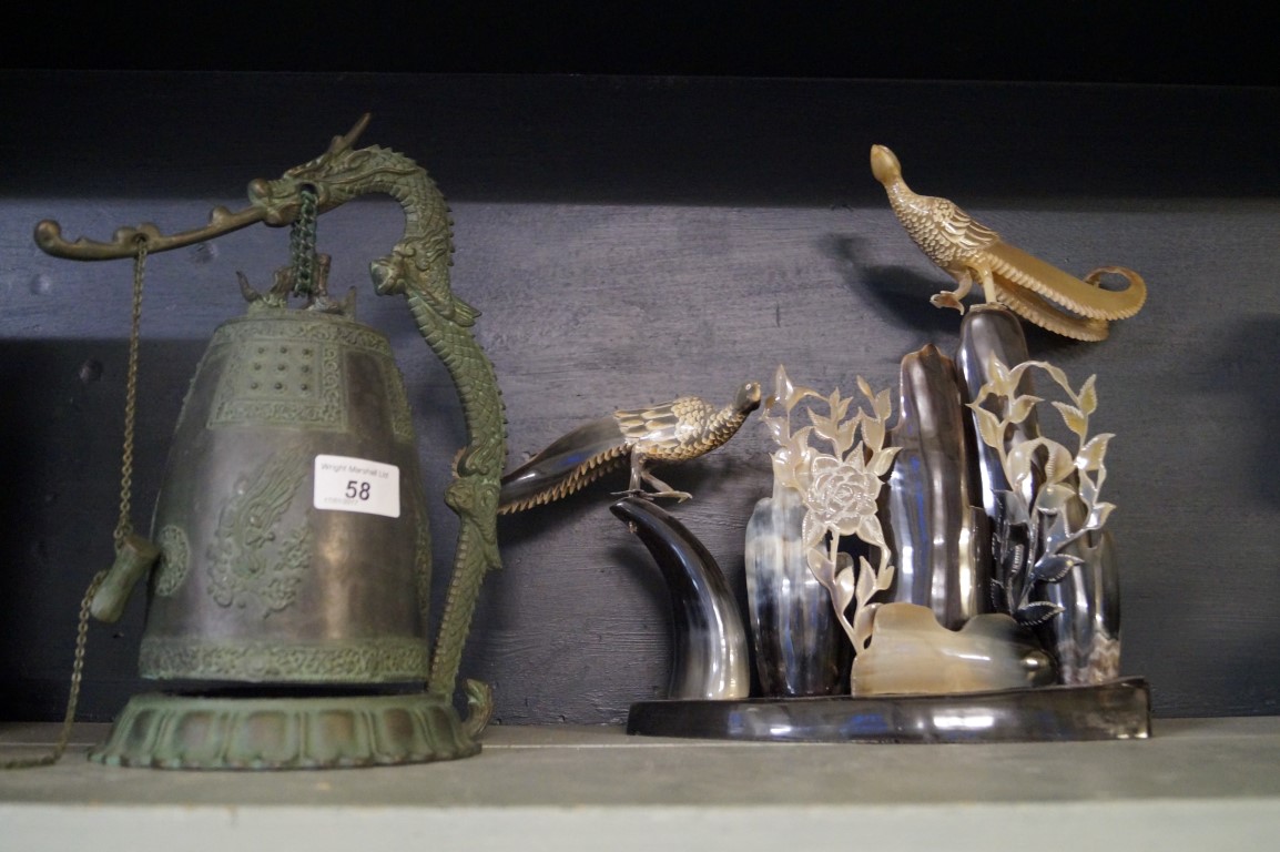 A modern Chinese gong together with a vintage horn sculpture.