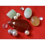 A collection of loose gem stones, to include; moonstone,