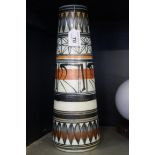 A contemporary studio pottery vase of slender cylindrical form, painted with geometric decoration,