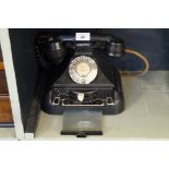 A vintage bakelite telephone.