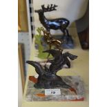 Three Art Deco spelter figures to include a stag, two birds fighting and a deer.