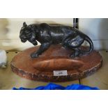 An early to mid 20th Century spelter ashtray depicting a stalking tiger on a marble base.