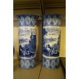 A pair of large blue and white cylindrical vases decorated in the Italian pattern.
