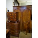 A reproduction mahogany four piece bedroom suite comprising twin door wardrobe,