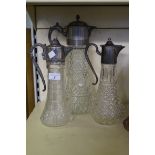Three 20th Century Claret jugs with silver plated and pewter collars.