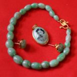 A jadeite jade bead bracelet, the clasp stamped 916, together with,
